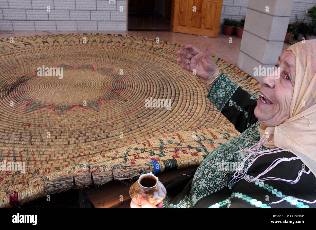 Jun 20, 2011 - Ramallah, West Bank - An elderly Palestinian woman, RASELAH ABED AL-HAFEZ, 70, prepares what she calls the biggest hay traditional dish, hoping to make it into the Guinness Book of Records. (Credit Image: © Issam Rimawi/apaimages/ZUMAPRESS.com) Stock Photo