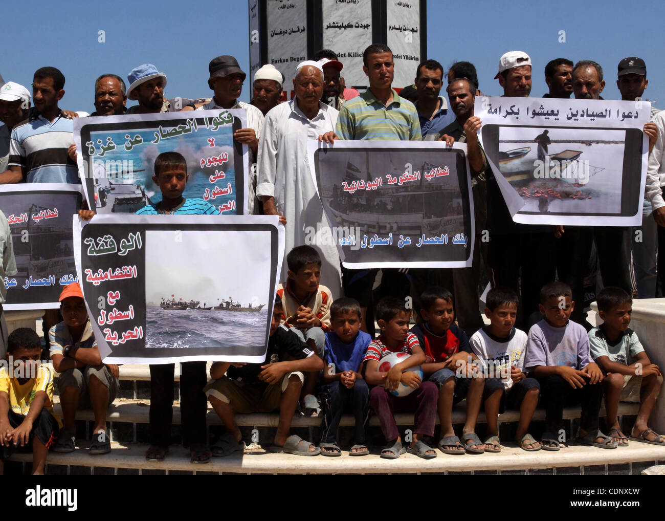 July 05, 2011 - Gaza City, Gaza Strip - Palestinian fishermen and children hold banners during a rally in Gaza City in support of the international Freedom Flotilla hoping to breach Israel's sea blockade on Gaza as it remained banned by Greece from setting sail. (Credit Image: © Mohammed Asad/apaima Stock Photo
