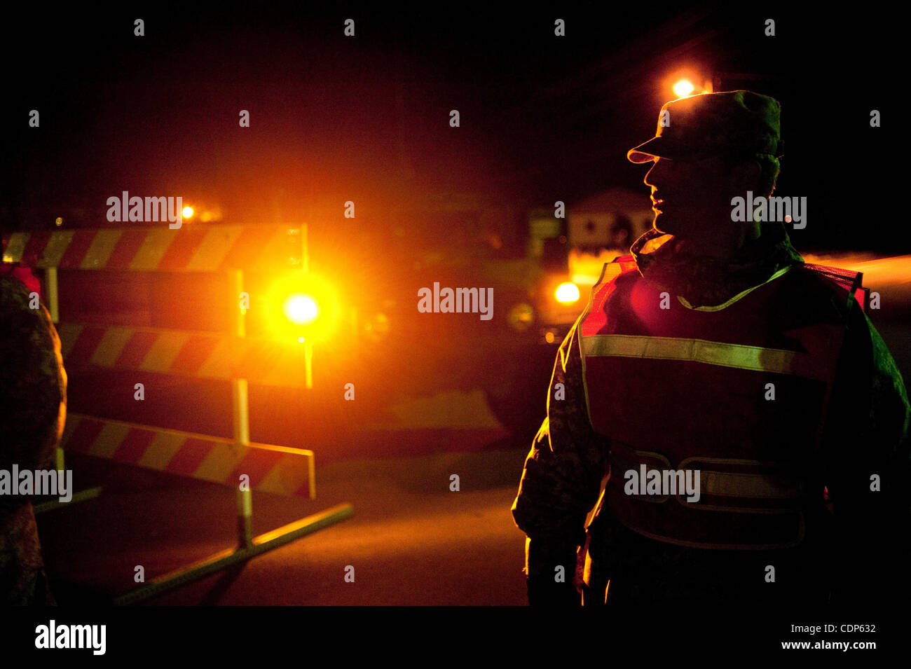 Apr 27, 2011 - Poplar Bluff, Missouri, U.S. - Private First Class Dakotah Vert waits at a check point on Route 53 on Wednesday night. Checkpoints were set to reduce looting and to keep people out of dangerously flooded areas. Vert struggled with boredom during his 12 plus hour shift. (Credit Image:  Stock Photo