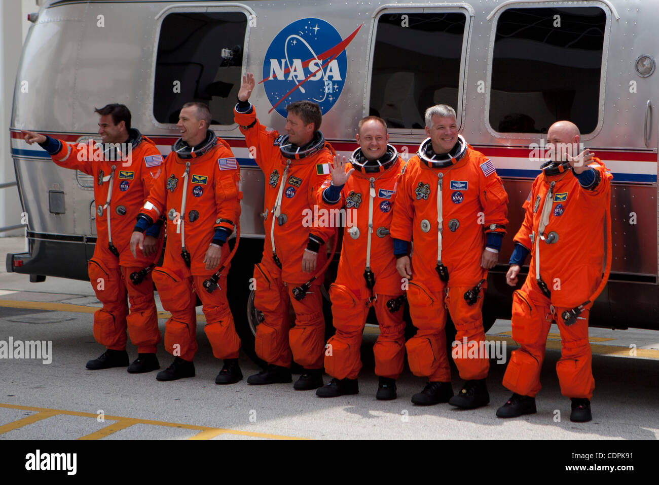 Cape Canaveral, Florida US - The crew of STS-134, (from left) mission specialists Greg Chamitoff, Drew Feustel, Roberto Vittori, Mike Fincke, pilot Greg H. Johnson and commander Mark Kelly, wave to those gathered outside the Operations and Checkout Building before leaving for the pad on April 29, 20 Stock Photo