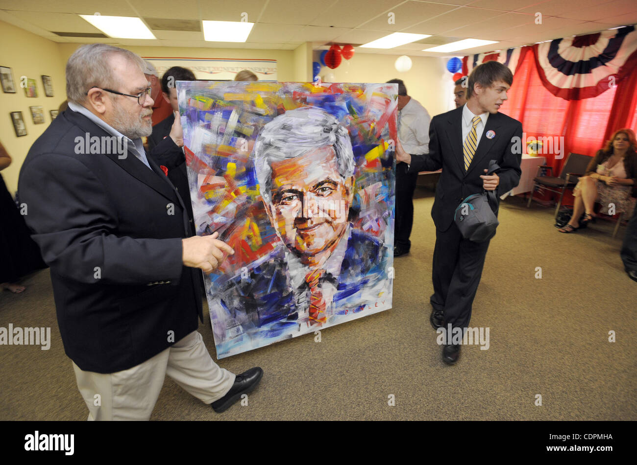 June 22, 2011 - Atlanta, GEORGIA, U.S. - Supporters Mel Steely (L) and Patrick Campbell carry in a portrait of Republican presidential candidate by artist Steve Penley before Gingrich's 68th birthday celebration at his campaign headquarters in Atlanta, Georgia, USA, 22 June 2011. Newt Gingrich turne Stock Photo