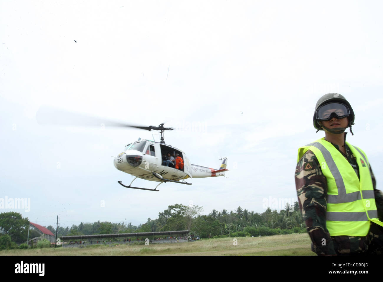 Apr 23, 2011 - Pantukan, Compostella Valley, Philippines - A chopper airlifting reporters and rescuers to search for people missing Saturday, after an avalanche of mud buried an illegal gold mining camp on Friday, April 22, 2011 is seen at the town proper of Pantukan in Compostella Valley in the sou Stock Photo