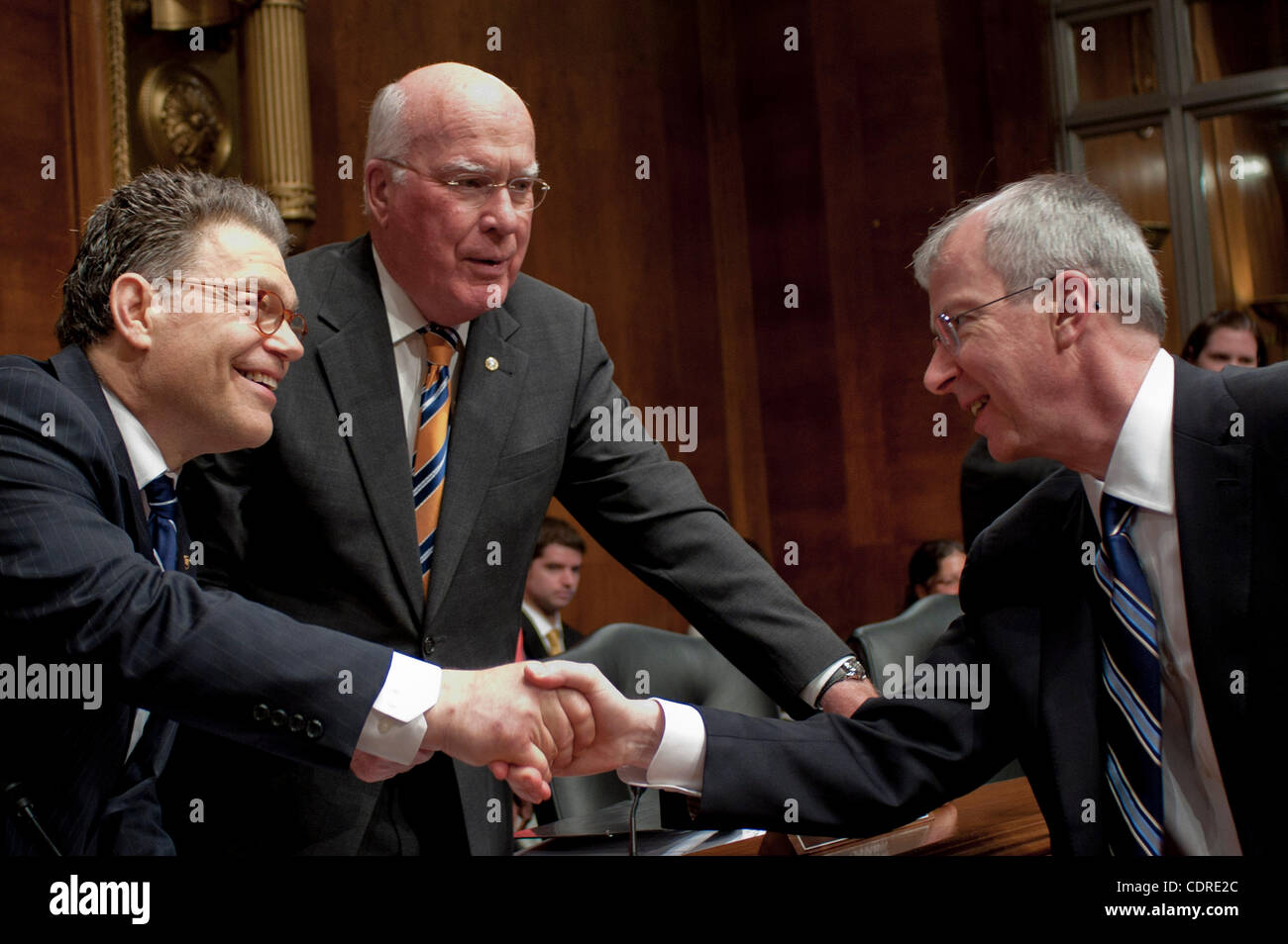 May 10, 2011 - Washington, District of Columbia, U.S. - GUY ''BUD'' TRIBBLE, vice president of software technology at Apple, Inc., is greeted by Senators AL FRANKEN (D-MN) and PATRICK LEAHY (D- VT) before testifying before a Senate Privacy, Technology and the Law Subcommittee hearing on ''Protecting Stock Photo