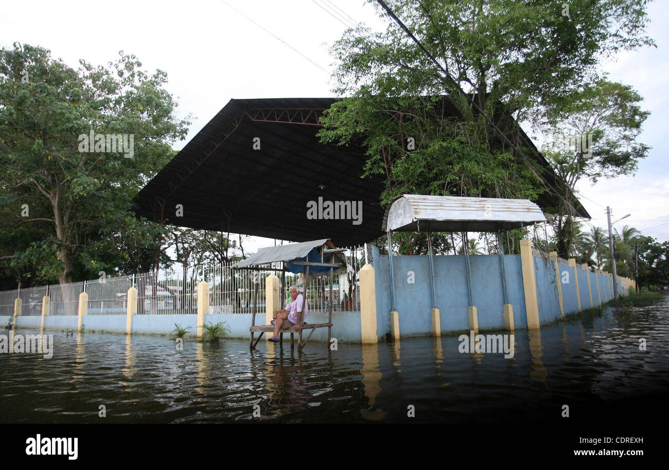 June 20, 2011 - Cotabato, Philippines - A Filipino man is seen in the southern flooded city of Cotabato in the southern Philippines. More than a half million people were displaced by the floods. The military said Tuesday that flashfloods in the region were caused by the clogging of tons of water lil Stock Photo