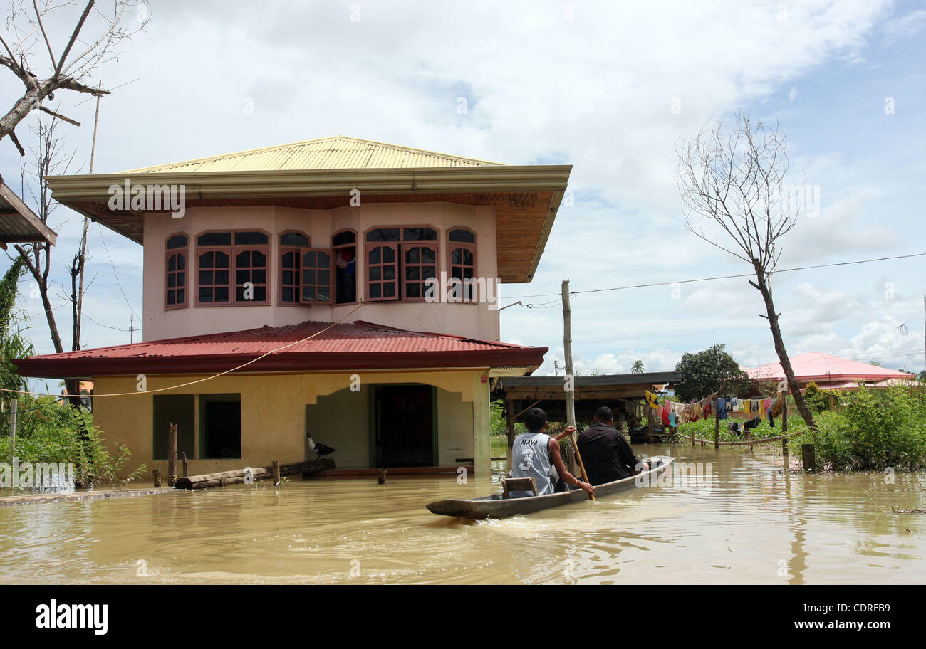 Jul 1, 2011 - Cotabato, Philippines - Filipino residents displaced by widespread flash floods are seen in the southern town of Sultan Kudarat in the southern Philippines, Friday. Flood waters in the region caused by the clogging of tons of water lilies subsided but in the city of Davao, flash floods Stock Photo