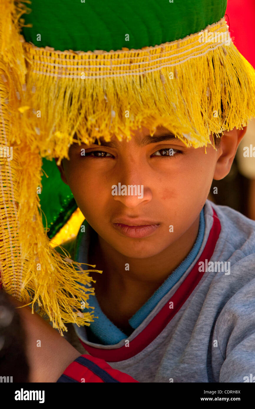 Benghazi, Libya, May 20th, 2011 - A boy hides from the midday sun under ...