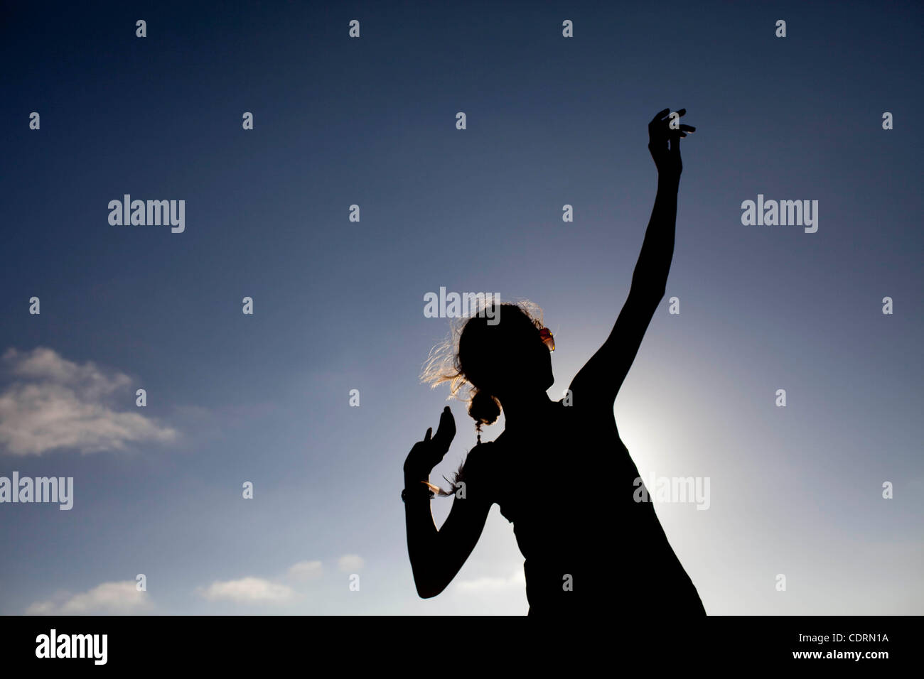 July 16, 2011 - San Clemente, California, U.S. - JULIE DZIKI is silhouetted against the sun while she dances during the beach concert on the first night of the Ocean Festival. (Credit Image: &#169; Andrew Dickinson/ZUMAPRESS.com) Stock Photo