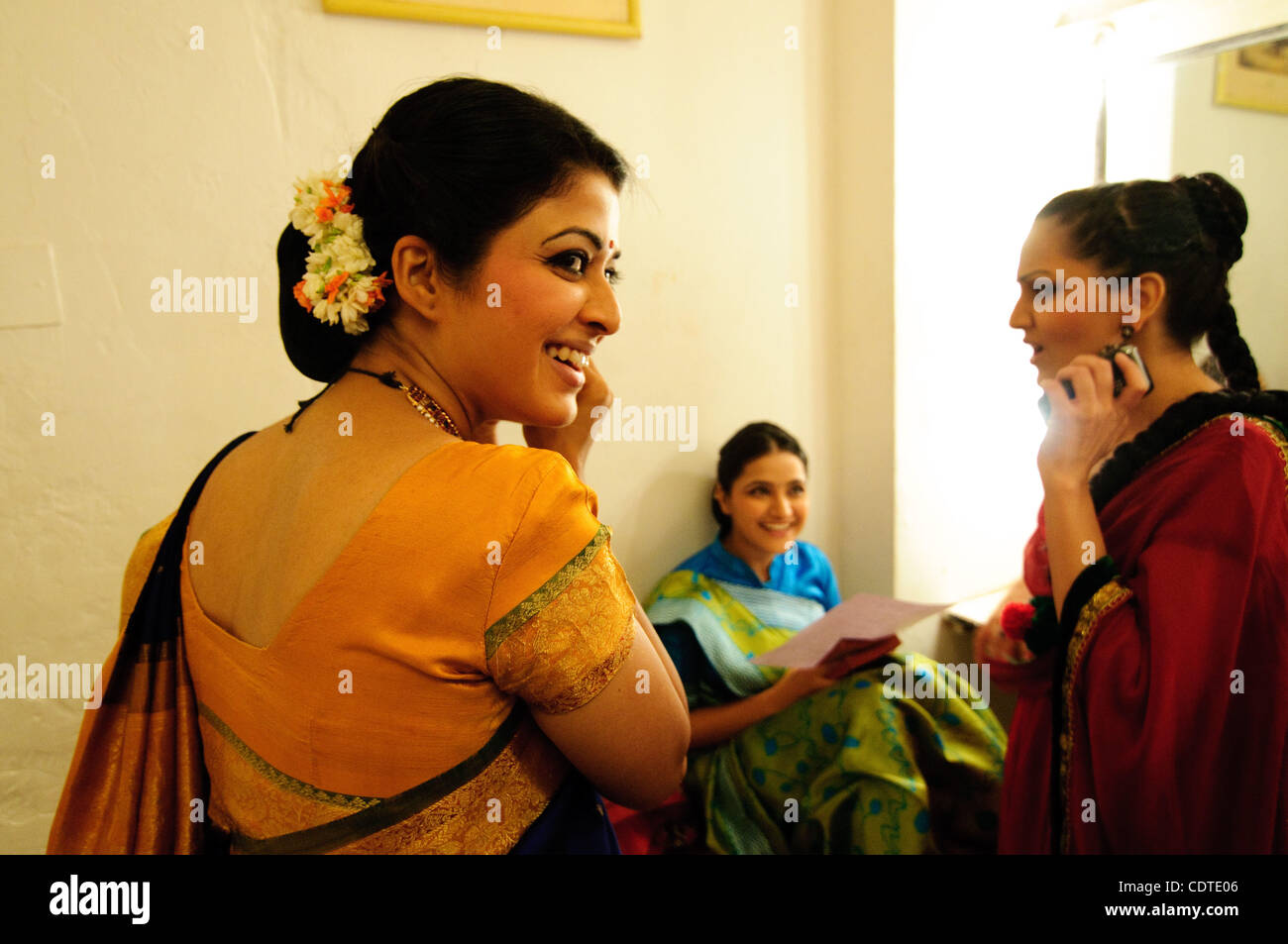 Actresses Anuradha Singh, Paroo Gambhir and Kavita Srinivasan get ready for a traditional food commercial at Future Studios just outside of Film City.  Each girl is dressed to represent a different area of India in order to incorporate it's wide variety of cultures.  Varying languages including Hind Stock Photo