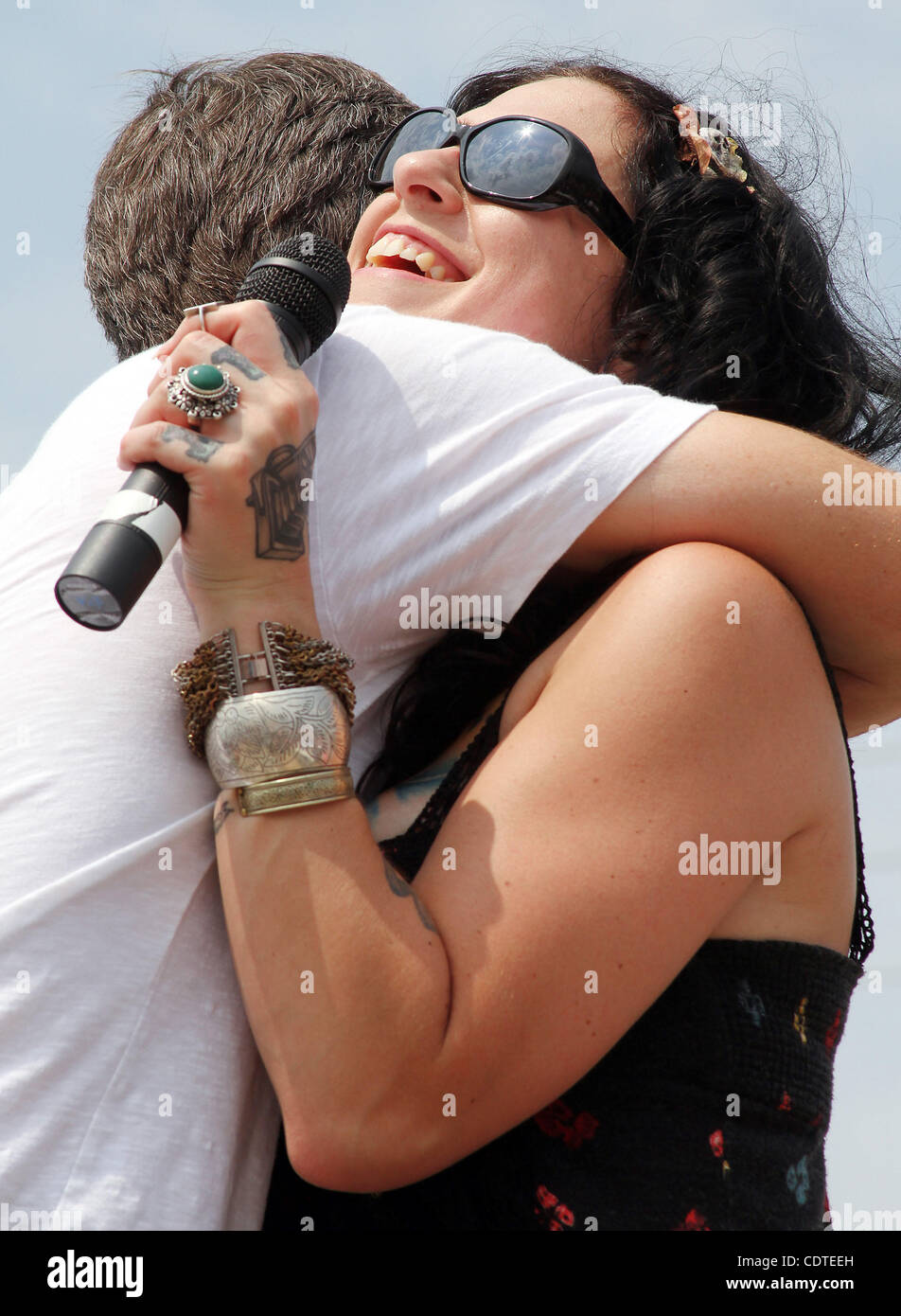 Mike Wolfe, left and Danielle Colby Cushman, two of the three stars on The History Channel's 'American Pickers,' laugh and hug during an appearance Saturday June 4, 2011 at the 'American Pickers' Weekend that brought an estimated 10,000 people to LeClaire, Iowa. Co-star Frank Fritz did not attend th Stock Photo