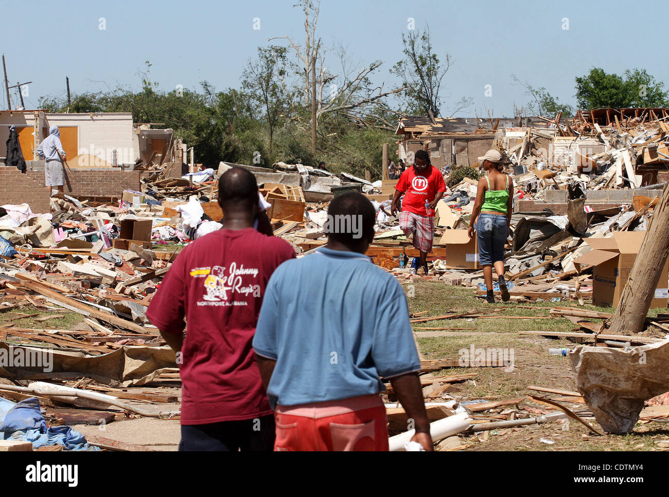 People go through the rubbile of what is left several days after tornadoes ravaged Tuscaloosa, Alabama USA, on 29 April 2011.  Over 100 have been confirmed dead in the state after deadly tornados destroyed homes and businesses yesterday. Stock Photo