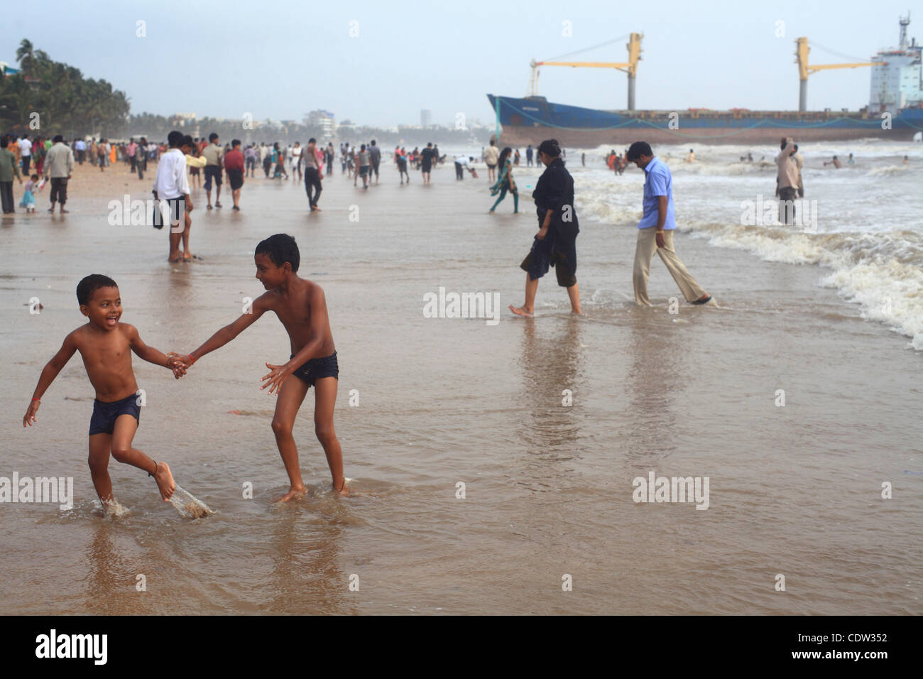 An unusual sight greeted the monsoon Revellers at the Juhu Chowpatty beach in Mumbai,India as the MV Wisdom,a merchant ship has been grounded since June 11 after it broke loose from the towing tug and it drifted ashore while it was being towed away to Alang shipyard to be broken down as scrap. Techn Stock Photo