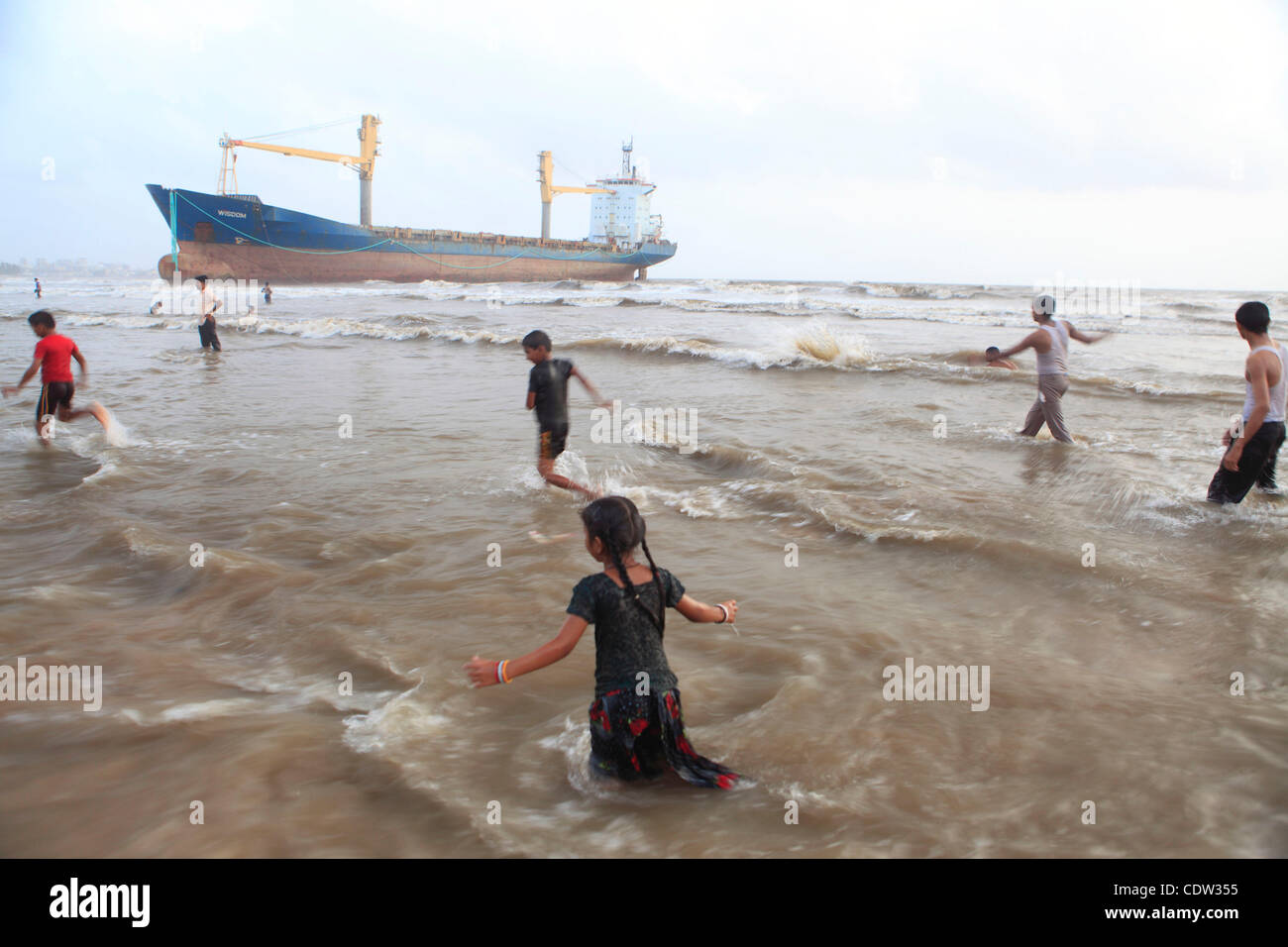 An unusual sight greeted the monsoon Revellers at the Juhu Chowpatty beach in Mumbai,India as the MV Wisdom,a merchant ship has been grounded since June 11 after it broke loose from the towing tug and it drifted ashore while it was being towed away to Alang shipyard to be broken down as scrap. Techn Stock Photo