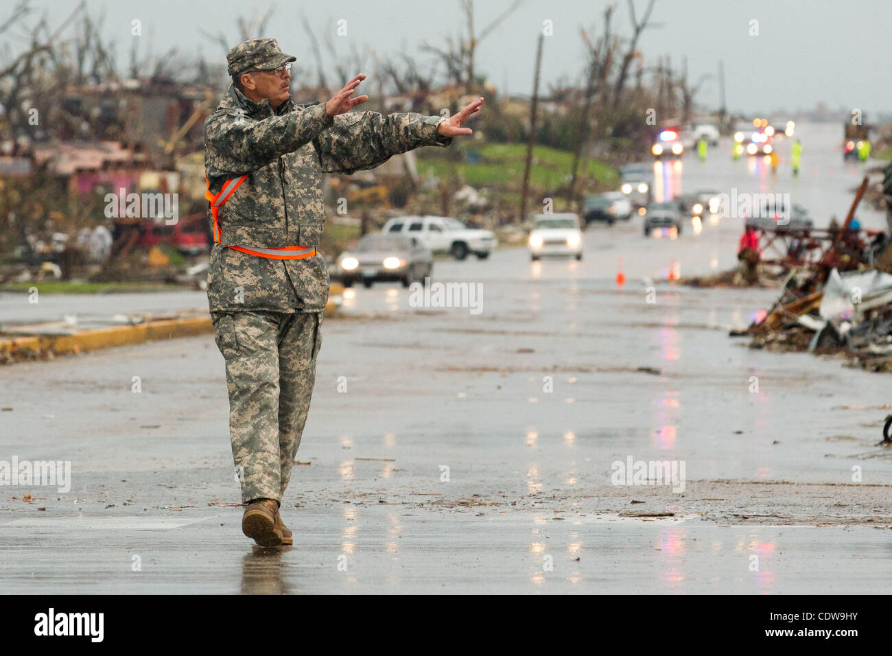 A Missouri National Guard member directs traffic in the intersection of East 20th Street and Ridge Lane Road in Joplin, Missouri after a Tornado came through the town on Sunday, May 22, 2011. Stock Photo