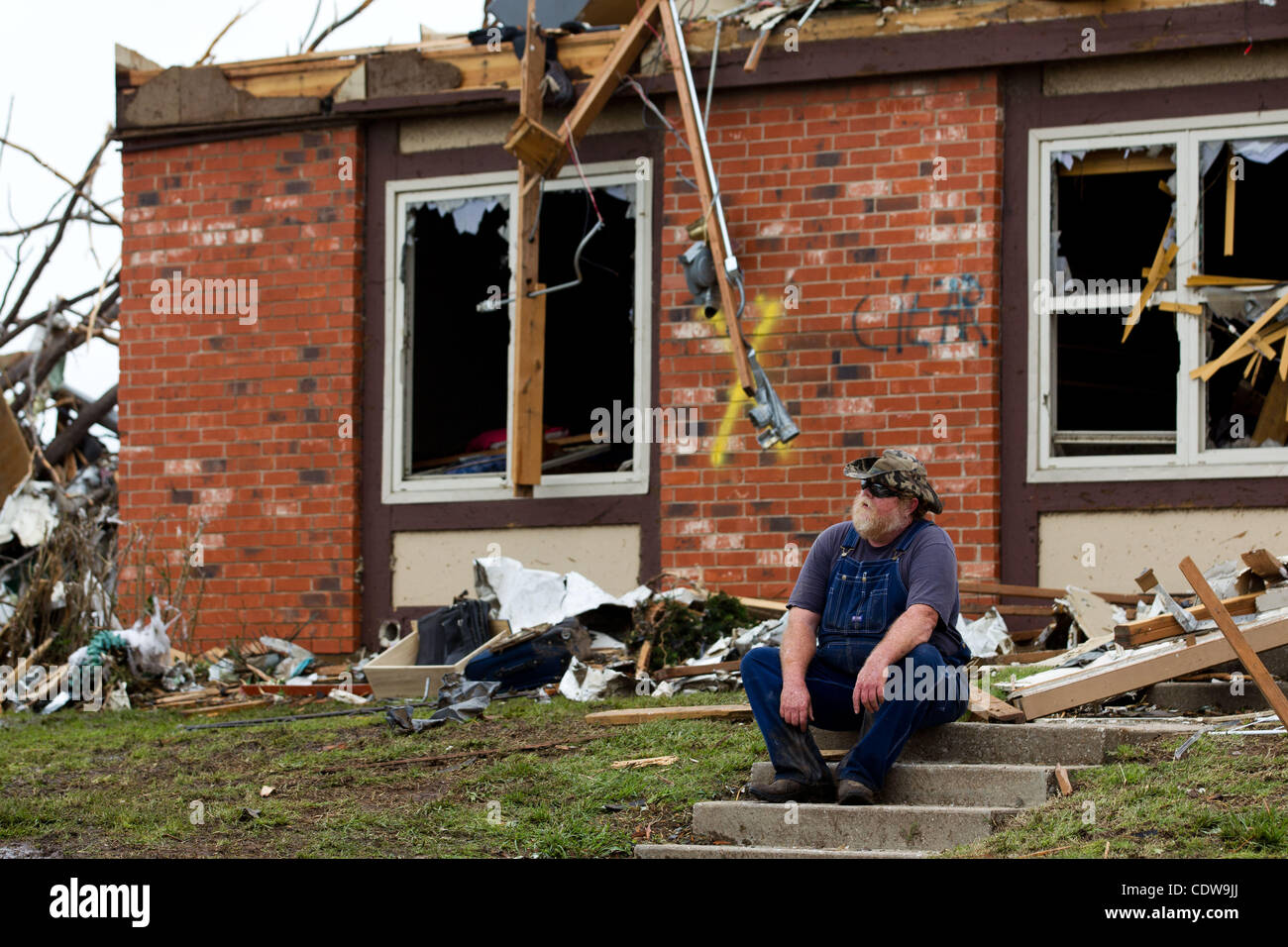 A resident of Joplin, Missouri sits on steps of a destroyed apartment