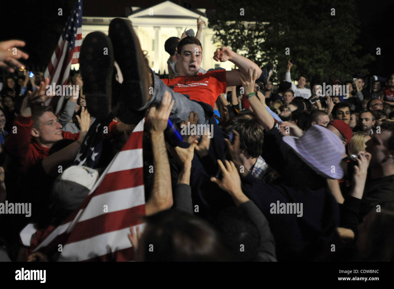 May 2, 2011 - Washington, District of Columbia, U.S. - Crowd surfing breaks out as thousands gathered at the White House in celebration after U.S. President Barack Obama announced the death of Al-Qaeda front man Osama bin Laden. (Credit Image: © Vaughn Wallace/ZUMAPRESS.com) Stock Photo