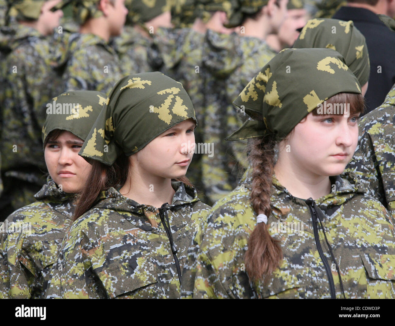 Russian teenagers are getting military skills during the summer training camp Zarnitsa for teenages organized by military-patriotic club.The event is taking place at the military base of 27th Rifle-infantry division near Moscow. Pictured: Russian girls teenagers during military training. Stock Photo