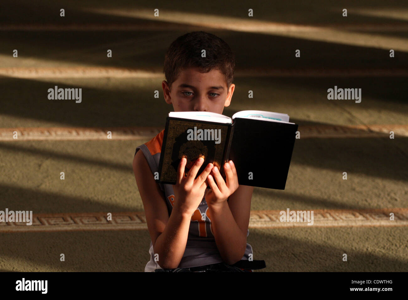 A Palestinian Boy Reads The Holy Koran At The Big Mosque In The