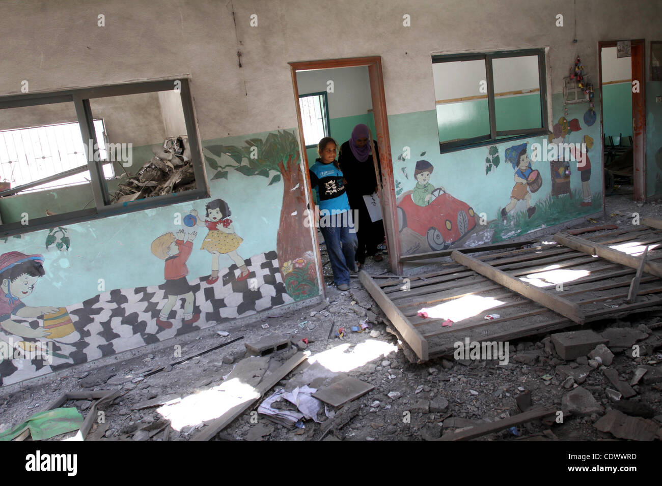 Palestinians inspect  the damage in the kindergarten that was destroyed by an overnight Israeli air raid in Beit Lahia, on August 25, 2011. A series of Israeli air strikes on Gaza over the past 24 hours have killed five Palestinians and injured 30, a spokesman for the emergency services told. Photo  Stock Photo