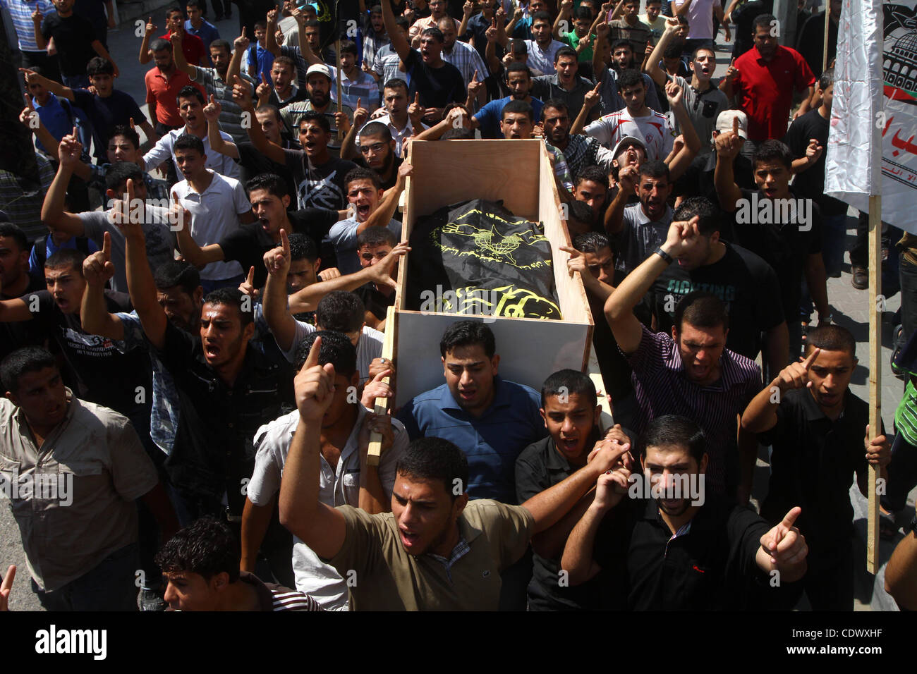 Palestinian mourners carry the body of Remah al-Hasani, a member of its military wing, the Al-Quds Brigades, during his funeral in Gaza city on Sep. 8, 2011. He was killed as he was driving in the central Deir al-Balah district of the territory, medics said. Photo by Ashraf Amra Stock Photo