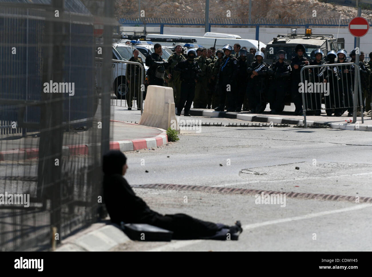 Sep. 17, 2011 - Ramallah, West Bank - A Palestinian woman who identified herself as NEDA, from the West Bank city of Bethlehem, sit in defiance within the crossing point of Qalandia at the entrance of Jerusalem, in a zone otherwise strictly forbidden for pedestrian. She told reporters that her only  Stock Photo
