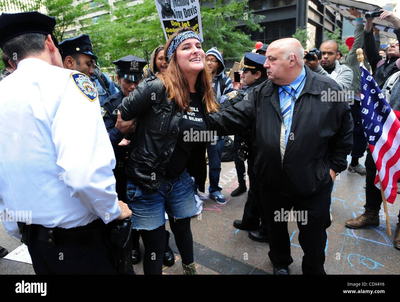 Sept. 19, 2011 - Manhattan, New York, U.S. - Andrea Osbourne of, 19 of Bushwick is arrested by police for writing in chalk on the sidewalk as demonstrators gather in Zuccotti Park to voice and discuss their frustration with the economy and Wall Street this morning. The demonstrators, who descended o Stock Photo