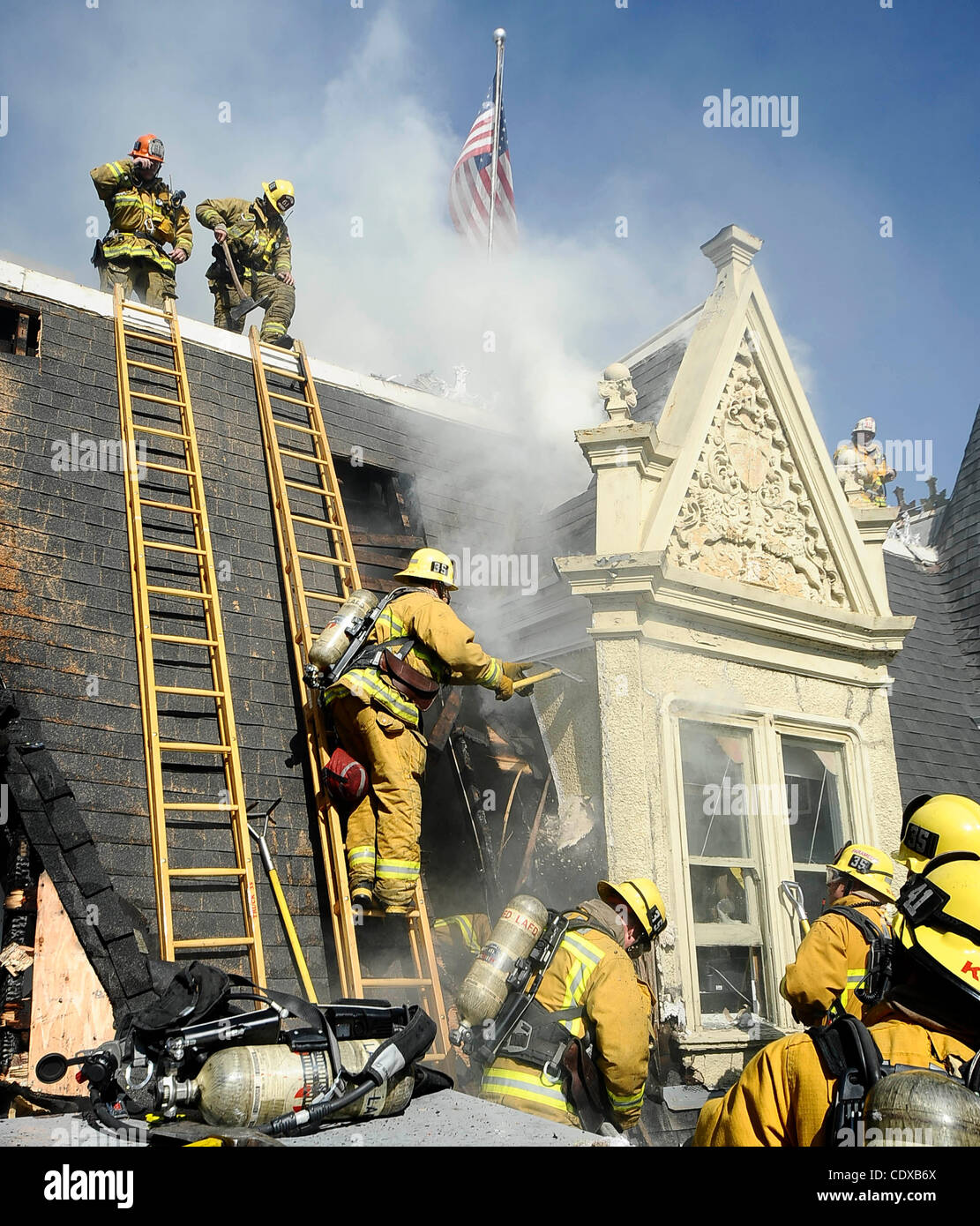 OCT 31,2011 - HOLLYWOOD, California, USA. Los Angeles city firefighters battle a fire at the famous Magic Castle in Hollywood CA. The fire started on the third floor were workers were doing some repairs and a fire started and got into the attic of the offices. The fire was knockdown in and one hour  Stock Photo