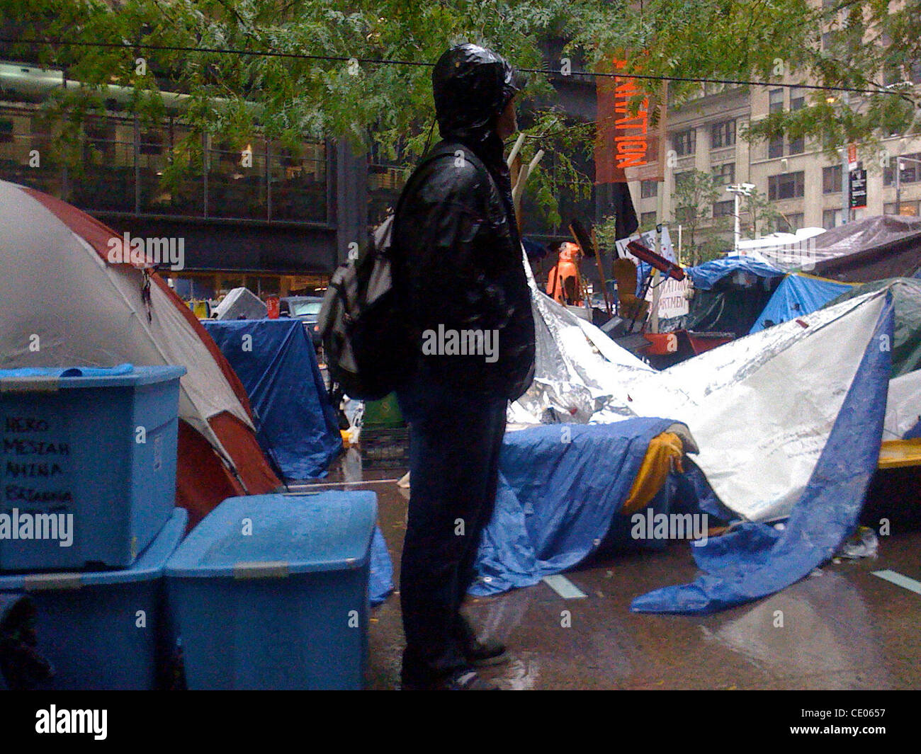 Occupy Wall Street protester braves the rain at Zuccotti Park. Stock Photo