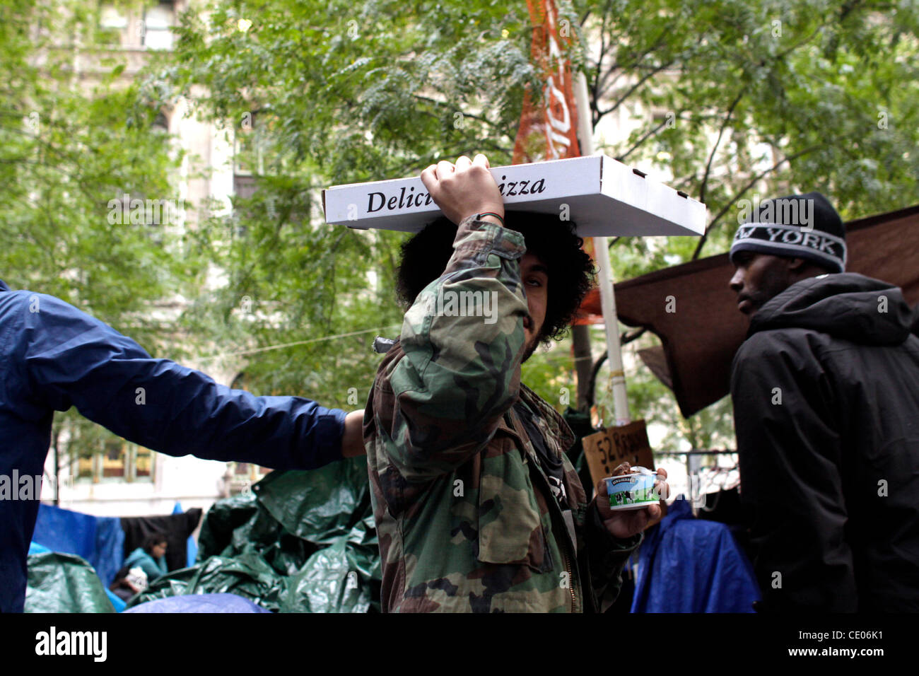 A protester with pizza at Occupy Wall Street in Zuccotti Park. Stock Photo