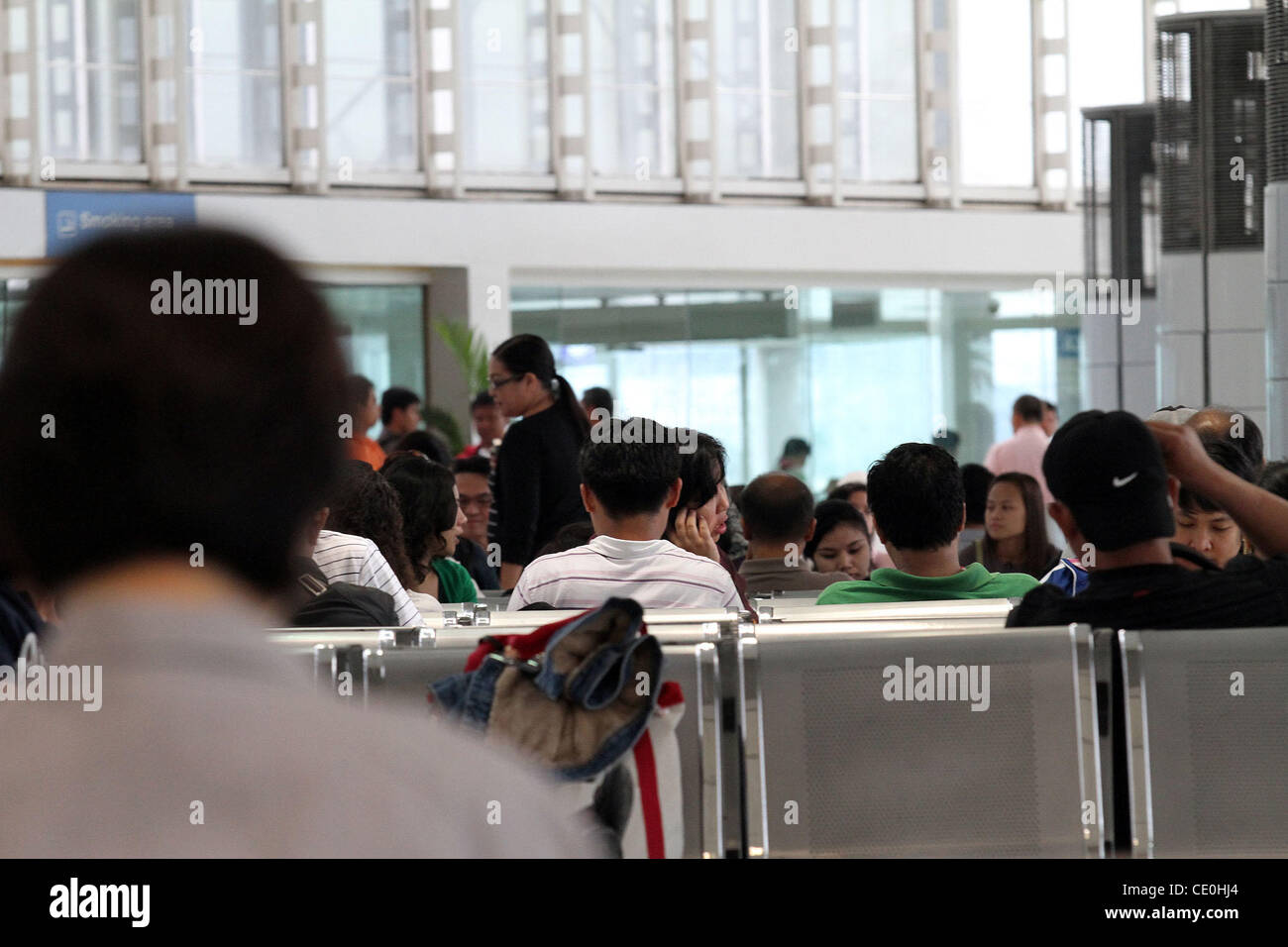 MANILA ‚Äì Passengers seen at the Ninoy Aquino International Airport in Manila, Philippines on Friday, August 19, 2011. Stock Photo