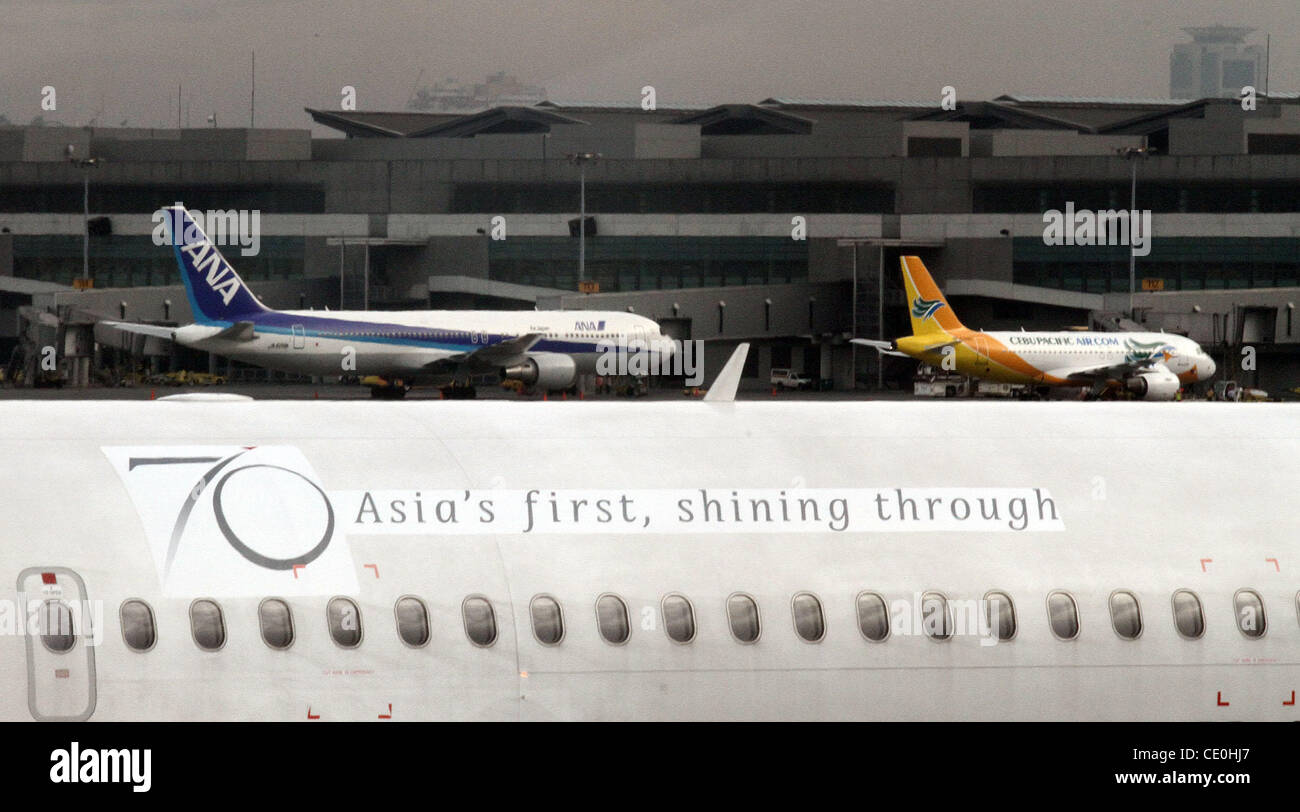 MANILA ‚Äì Commercial planes are seen at the Ninoy Aquino International Airport in Manila, Philippines on Friday, August 19, 2011. Stock Photo