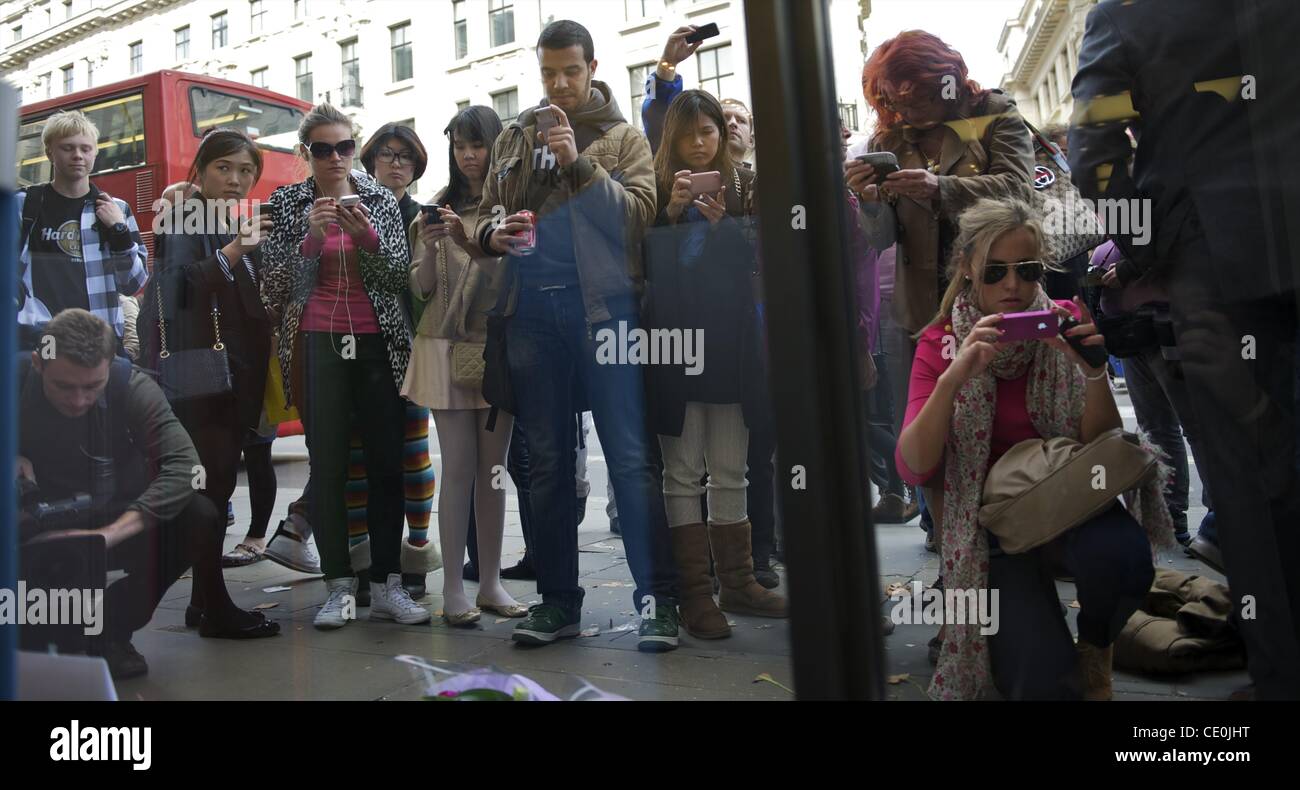 Oct. 6, 2011 - Manchester, England, UK - People photograph a memorial for visionary Apple CEO and co-founder STEVE JOBS outside the London Regent Street Apple store. (Credit Image: © Mark Makela/ZUMAPRESS.com) Stock Photo