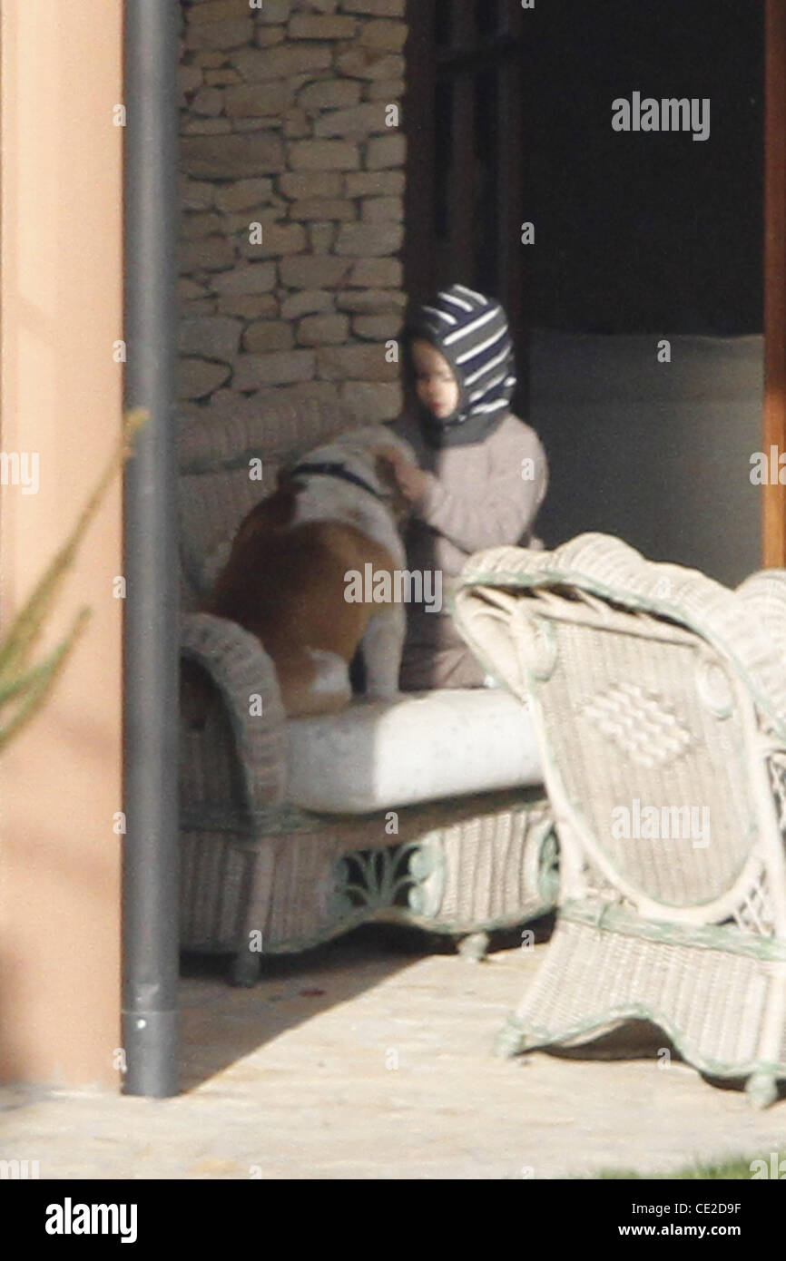 Shiloh Jolie-Pitt playing with the family's dog. Budapest, Hungary - 05.11.2010 Stock Photo
