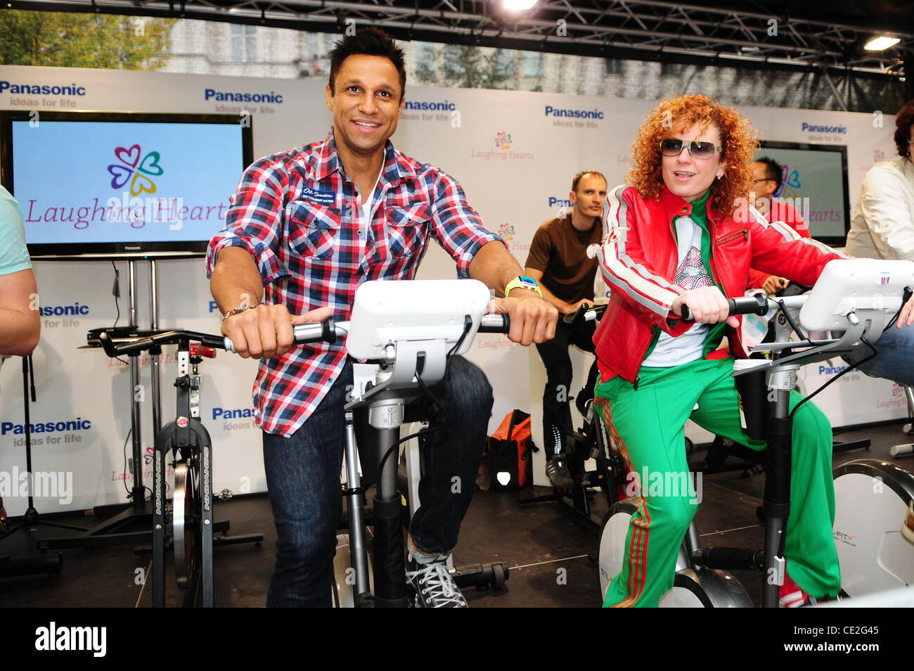 Lucie Diakowska and Christian Aminati working out on an exercise bike