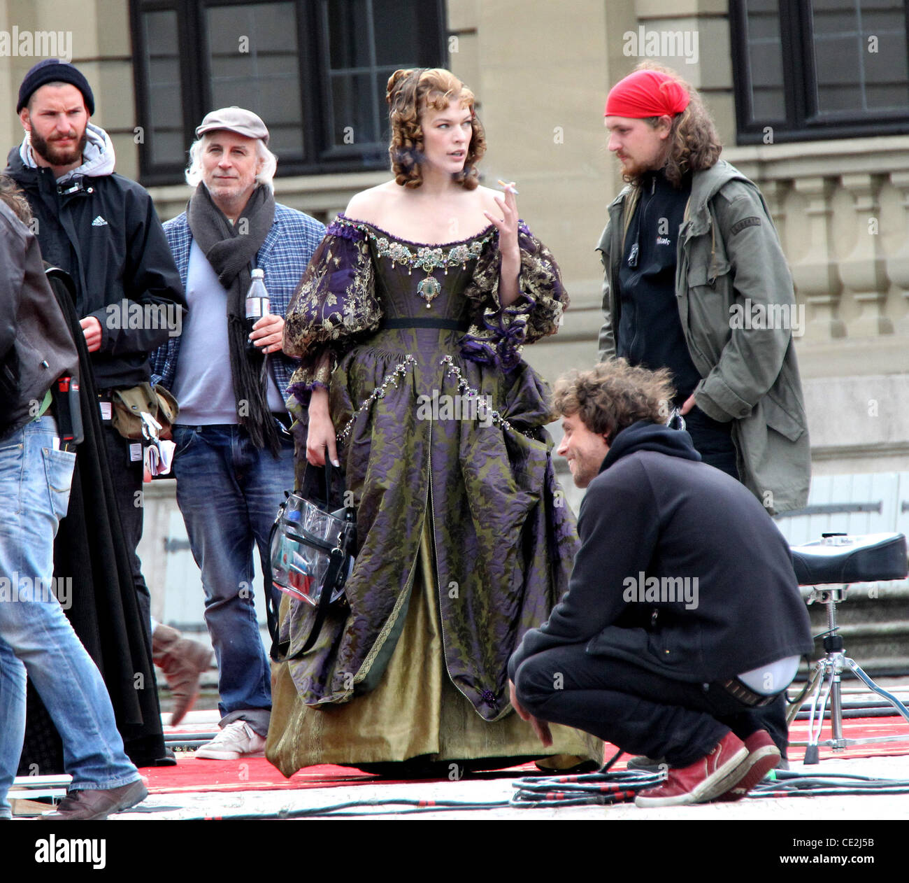 milla jovovich smoking cigarettes Milla Jovovich lights up a cigarette on the set of 'The Three Musketeers'  at Residenz Wuerzburg