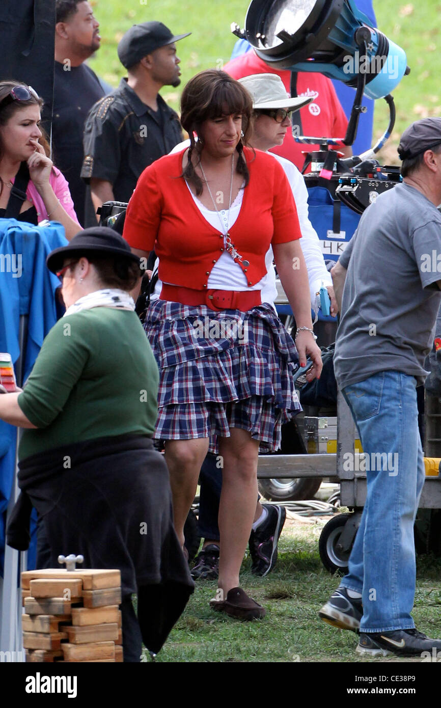 Adam Sandler dressed as a woman in a red cardigan and skirt, on the movie  location set for the feature film 'Jack and Jill' at a park in Hollywood.  Los Angeles, California -