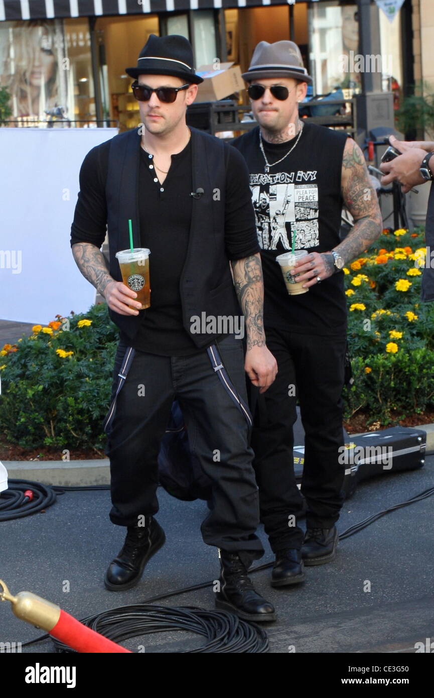 Joel Madden and Benji Madden Good Charlotte brothers drinking Starbucks beverages at The Grove