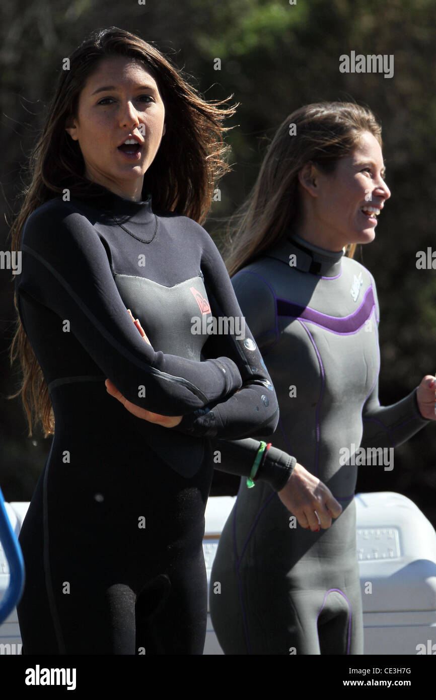 Cast members of the television show '90210' film a beach scene with wetsuits and surfboards in