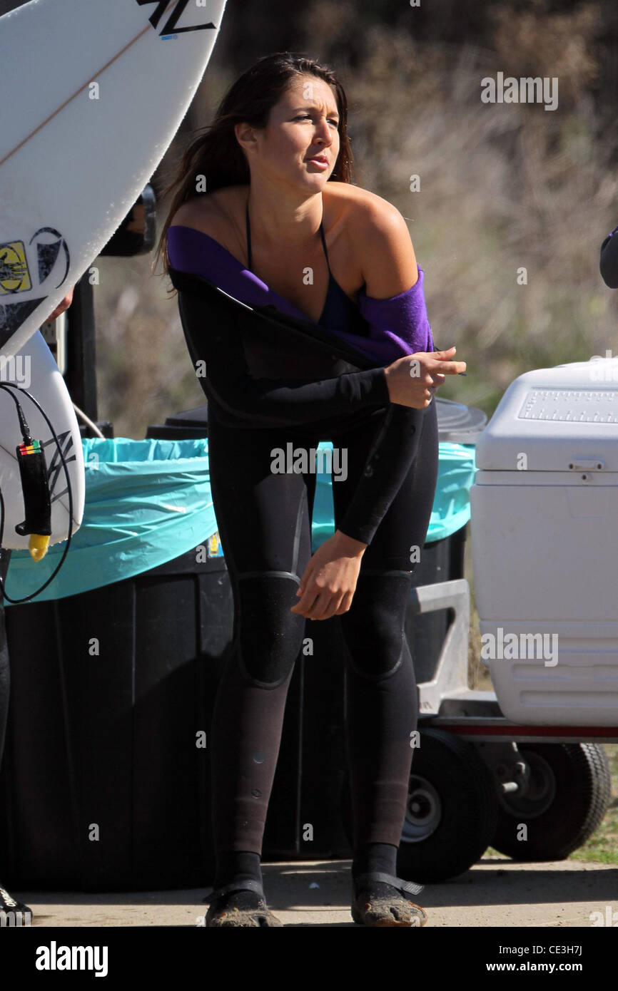 Cast members of the television show '90210' film a beach scene with ...
