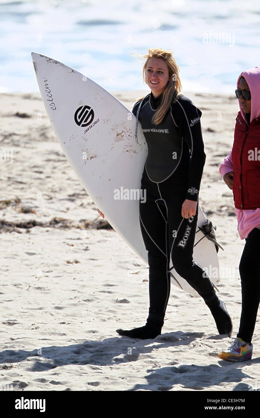 Cast members of the television show '90210' film a beach scene with wetsuits and surfboards in
