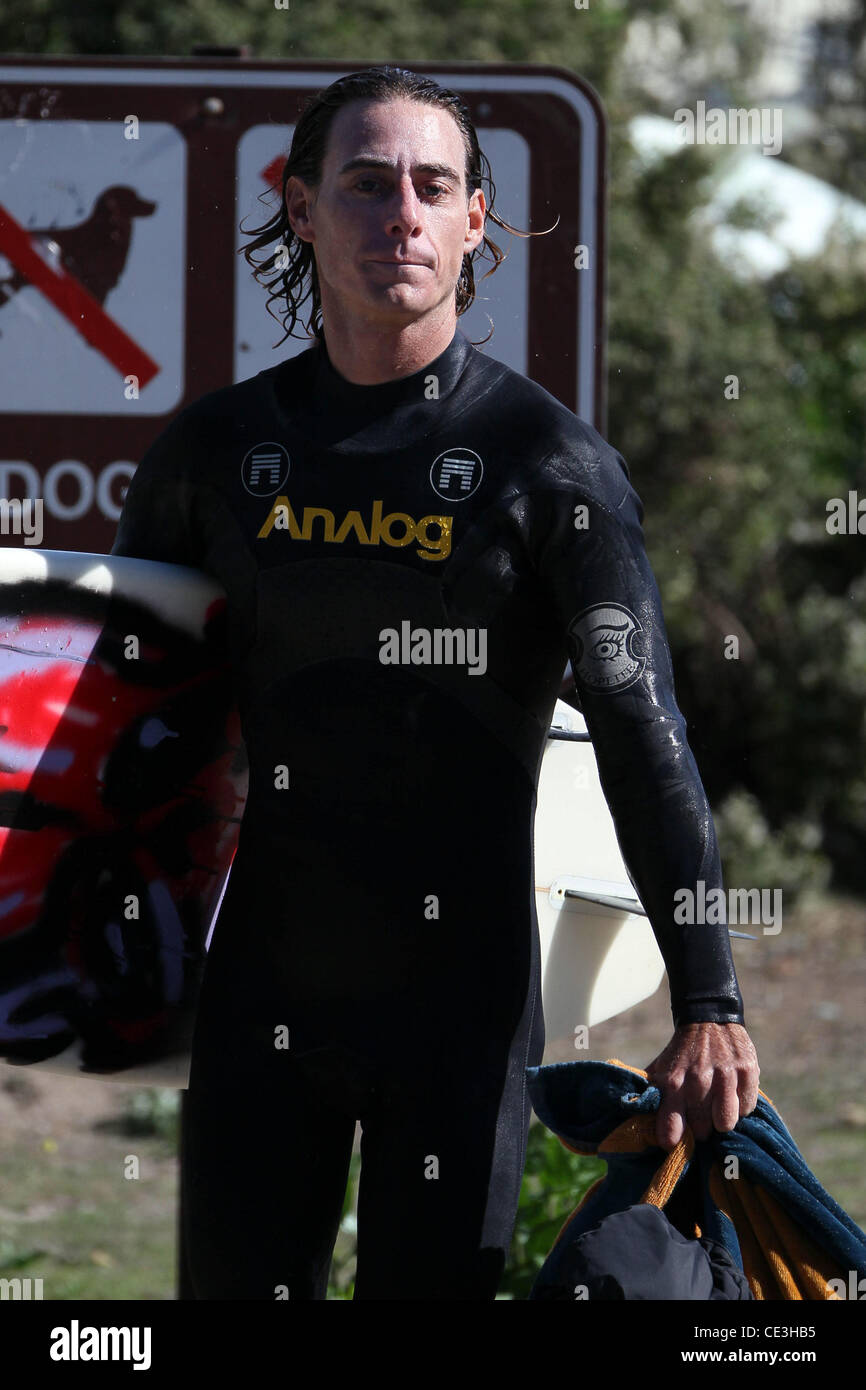 Cast members of the television show '90210' film a beach scene with wetsuits and surfboards in