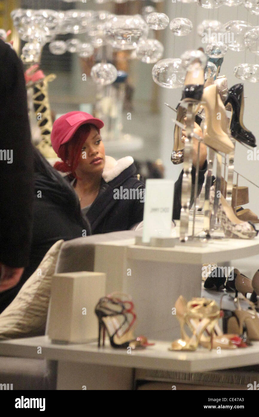Rhianna trying on shoes while out shopping at the Sax Fifth Avenue ...