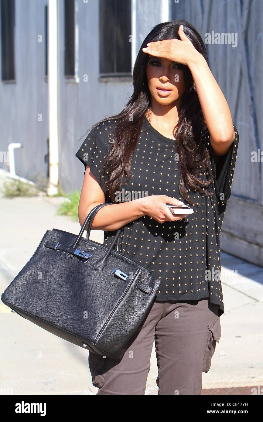 Kim Kardashian is seen wearing Ugg boots and an Hermes Birkin bag