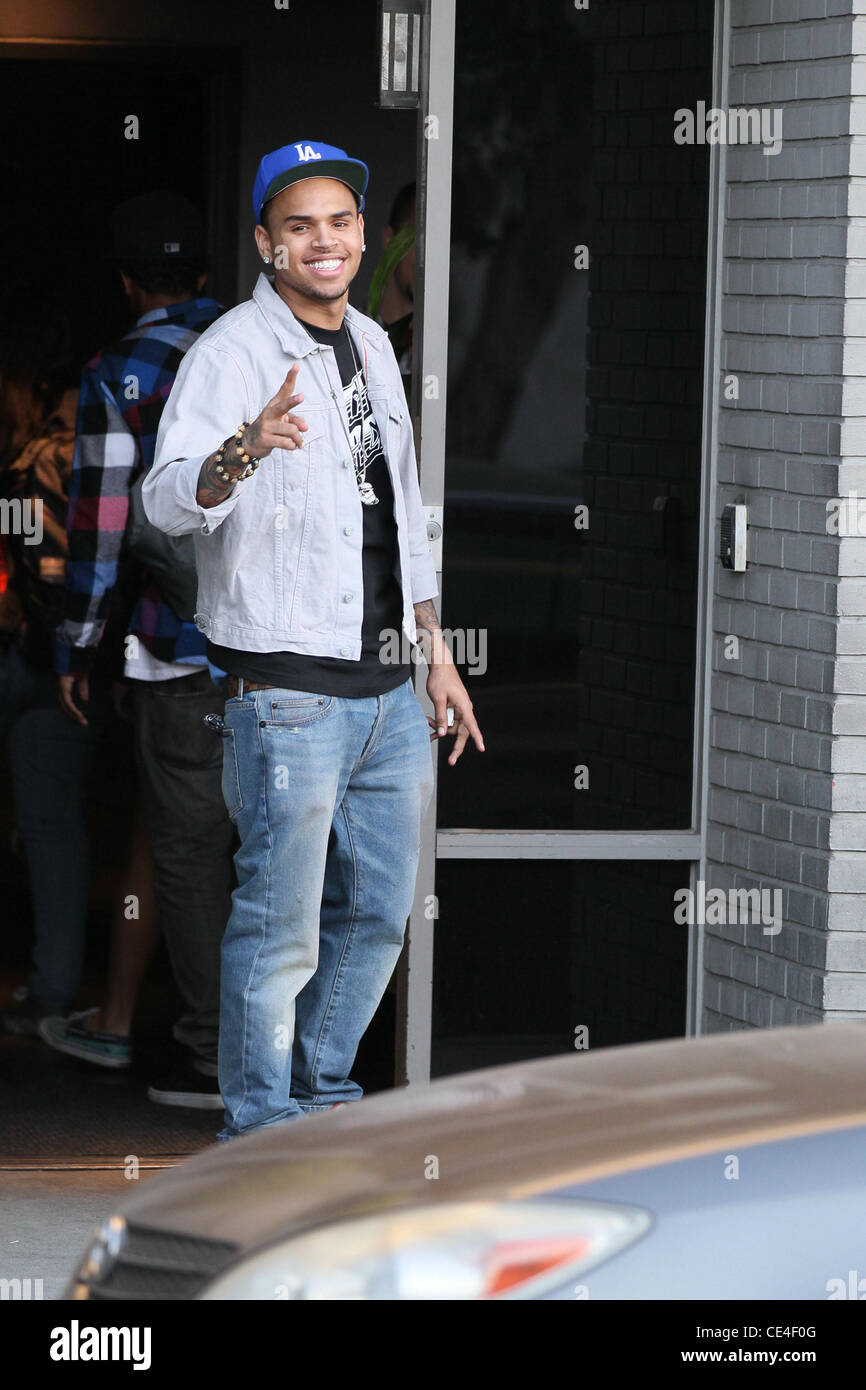 Chris Brown shows off in front of photographers outside a