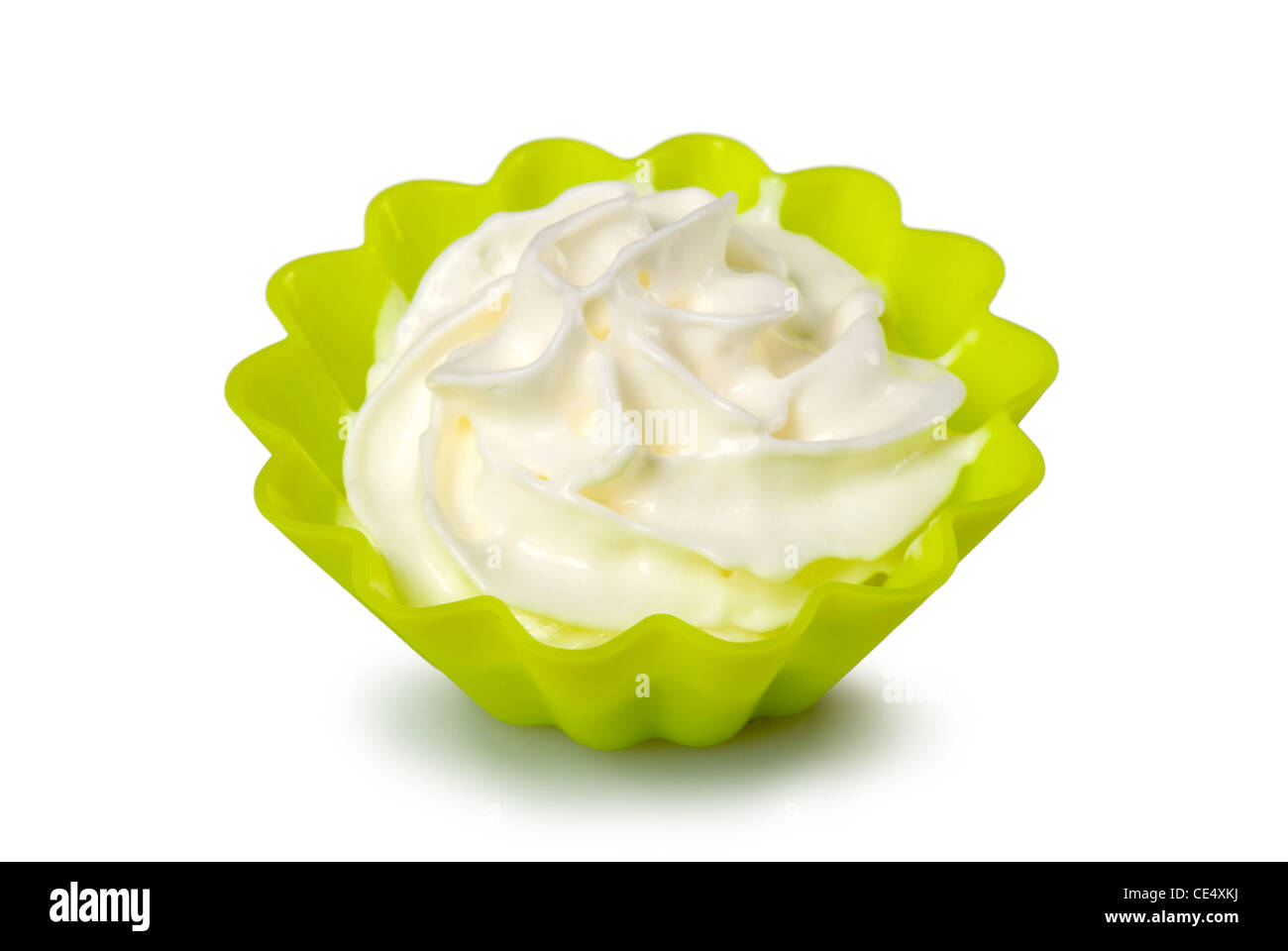 Portion of whipped cream over white background. Shallow DOF Stock Photo