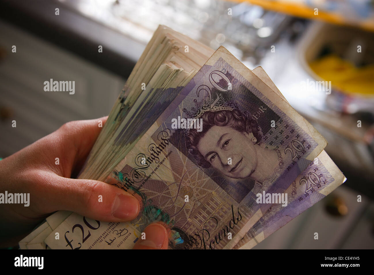 holding fan money £20 notes GBR sterling currency view landscape young man teenager model released hands stash wad Stock Photo