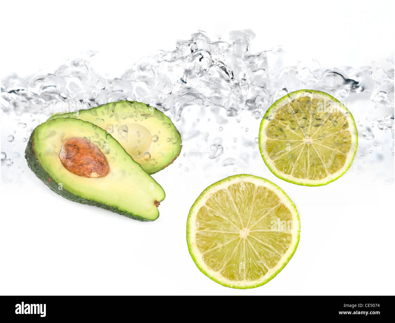 Green limes and avocado in water dropped isolated on a white Stock Photo