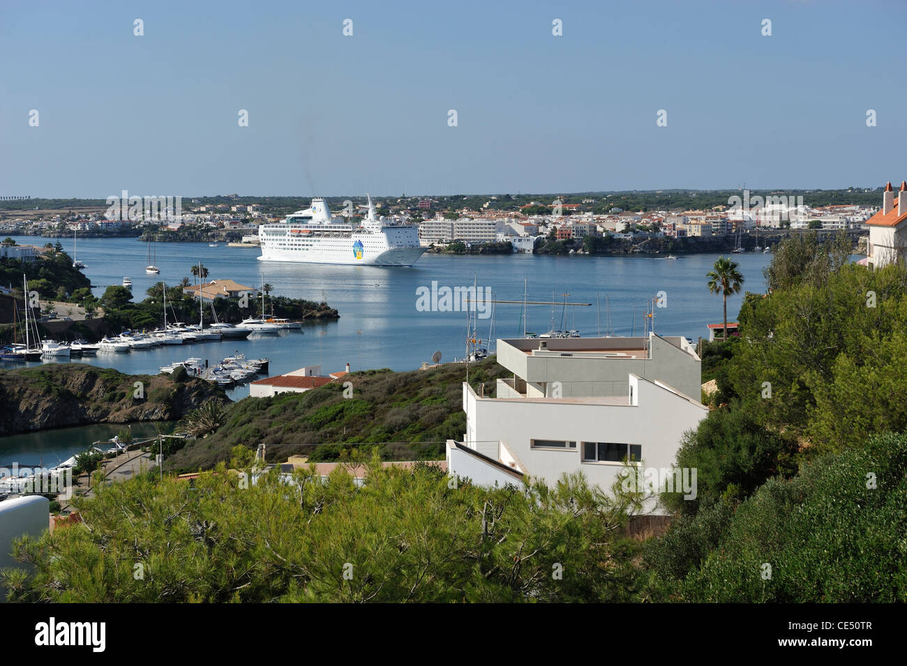 A Cruise liner passing Es Castell in Mao Mahon Harbour Menorca Spain one of the largest natural