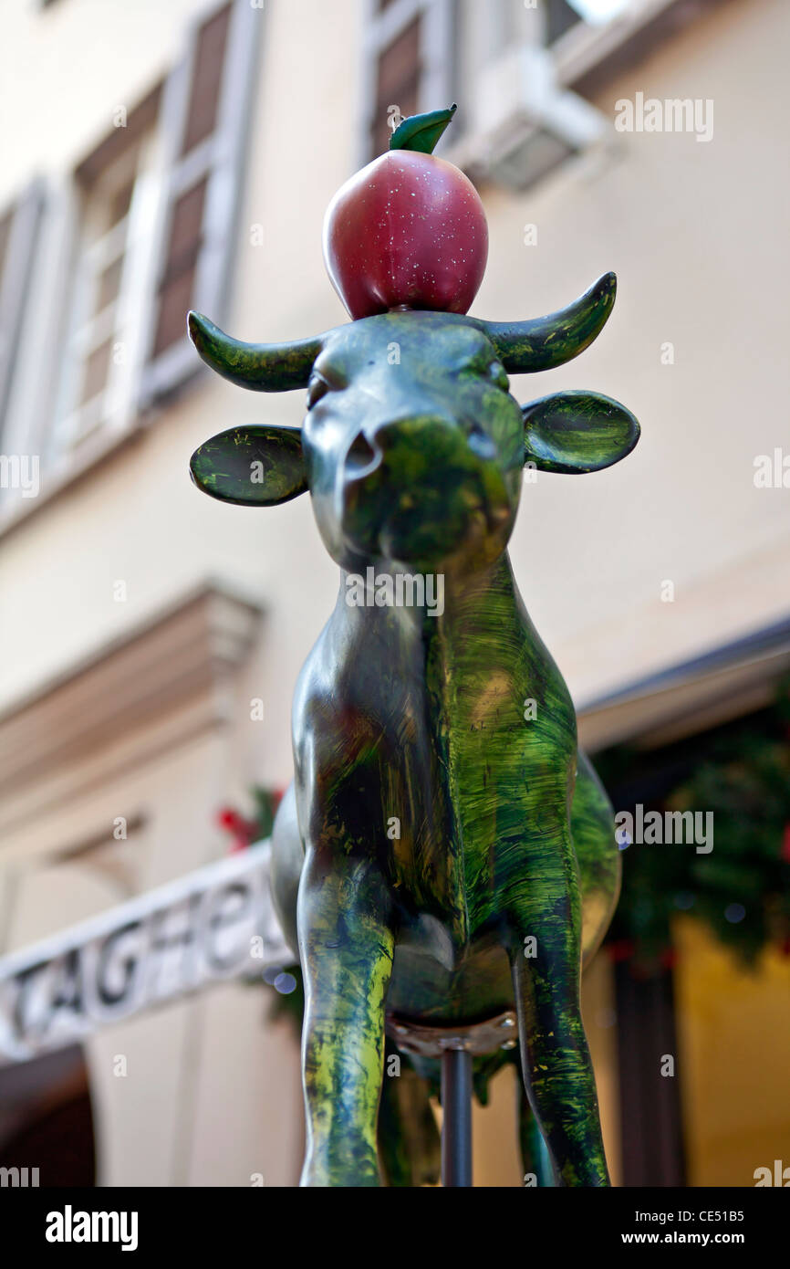 Symbol for Switzerland: Swiss cow with William Tell, apple on the head. Seen in Lugano, Ticino, Switzerland. Stock Photo