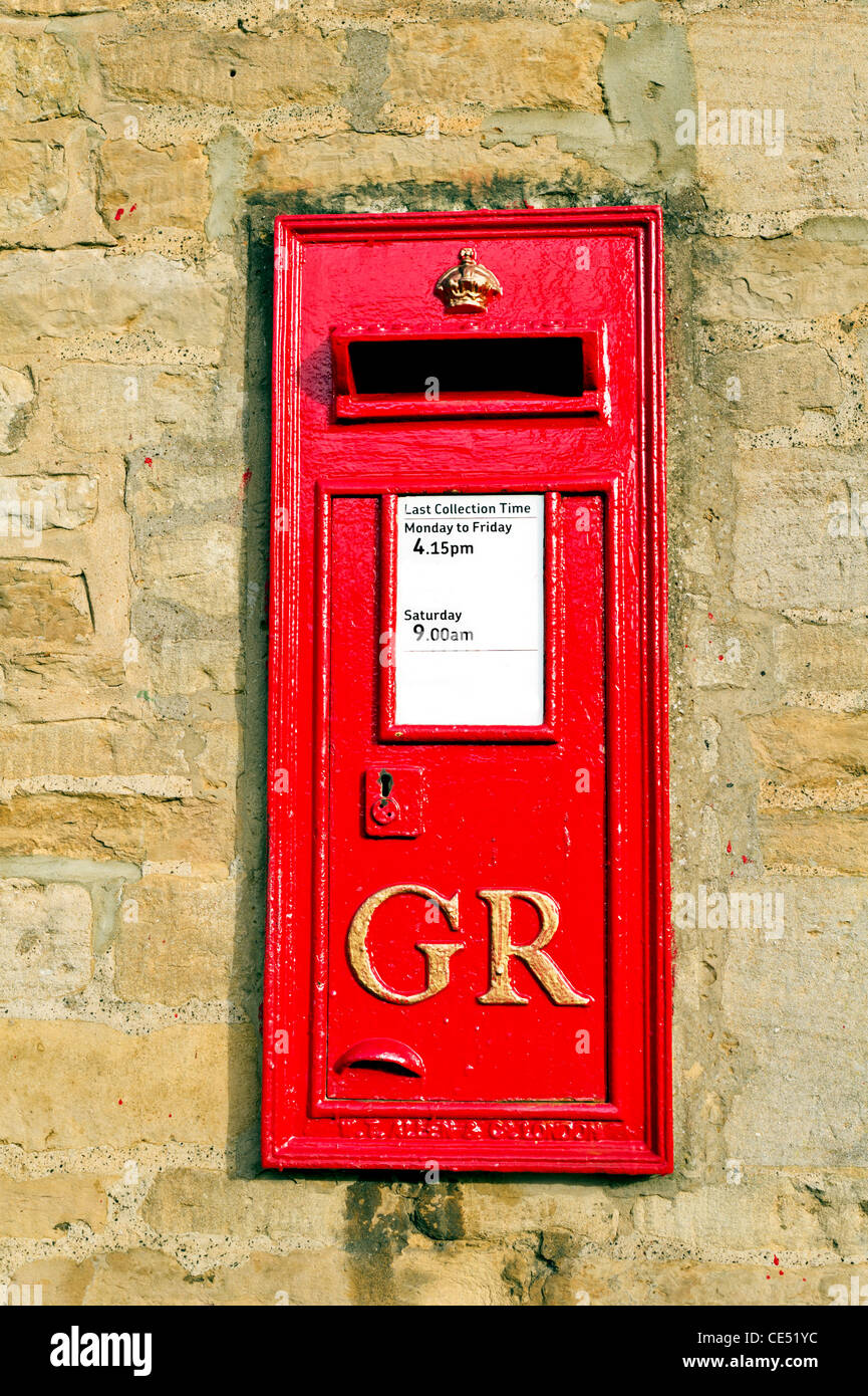 Post box set into the wall of a stone building in an english village, dating from the reign of King George VI (1936-52) Stock Photo