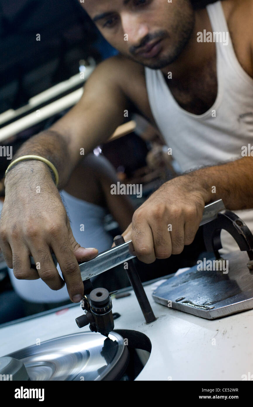 worker with dops polishing and inspecting diamond  Borivali Mumbai India Stock Photo